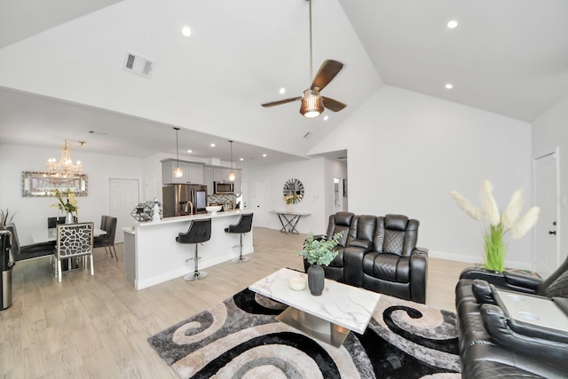 3707 Kingston Vale Dr, Houston, TX 77082 - living room with a ceiling fan, light wood-style floors, high vaulted ceiling, recessed lighting, and a chandelier