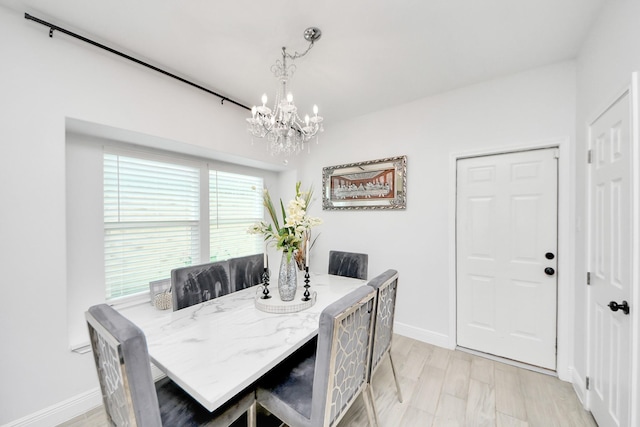 3707 Kingston Vale Dr, Houston, TX 77082 - dining area featuring a chandelier, baseboards, and light wood-style flooring