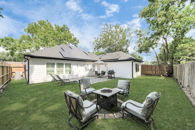 3707 Kingston Vale Dr, Houston, TX 77082 - rear view of house featuring a fire pit, solar panels, a patio area, and a shingled roof