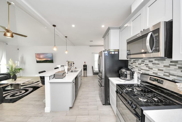 3707 Kingston Vale Dr, Houston, TX 77082 - kitchen featuring stainless steel microwave, range with gas cooktop, backsplash, light countertops, and recessed lighting