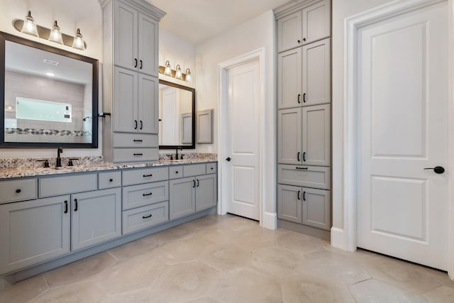 415 Faust Ln, Houston, TX 77024 - bathroom featuring double vanity and a tile shower