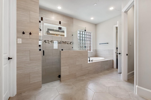 415 Faust Ln, Houston, TX 77024 - bathroom featuring a garden tub, a shower stall, tile patterned flooring, and recessed lighting