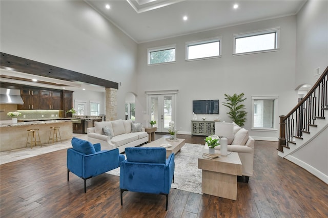 7737 Brookside Rd, Pearland, TX 77581 - living area featuring a towering ceiling, crown molding, dark wood-type flooring, stairway, and baseboards