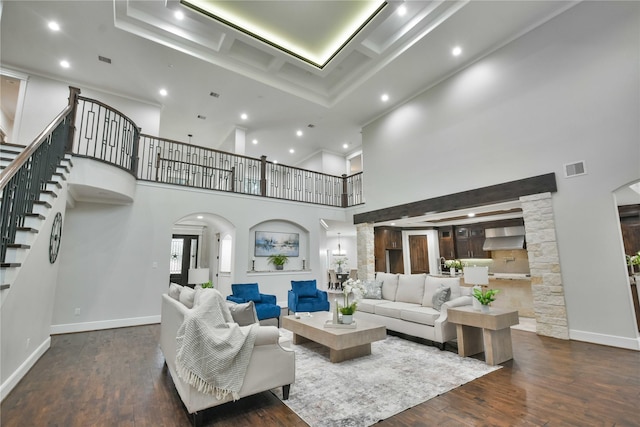 7737 Brookside Rd, Pearland, TX 77581 - living room featuring arched walkways, hardwood / wood-style flooring, recessed lighting, stairs, and a towering ceiling