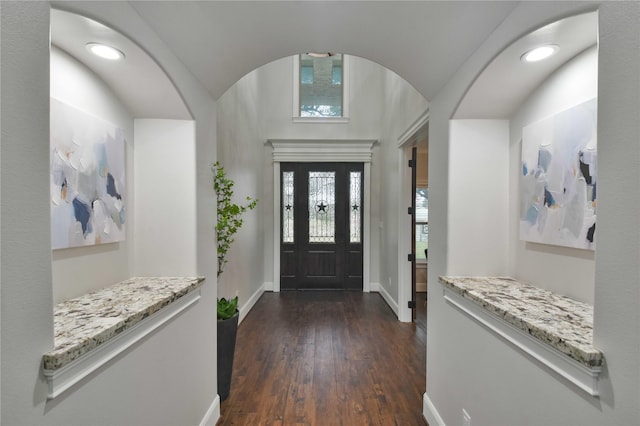 7737 Brookside Rd, Pearland, TX 77581 - foyer with baseboards, dark wood finished floors, vaulted ceiling, and arched walkways