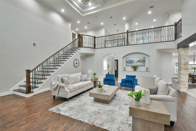 7737 Brookside Rd, Pearland, TX 77581 - living room with stairway, a towering ceiling, wood finished floors, recessed lighting, and arched walkways