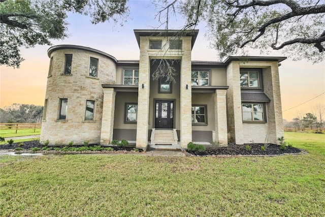 7737 Brookside Rd, Pearland, TX 77581 - view of front facade with a front yard, stucco siding, and stone siding