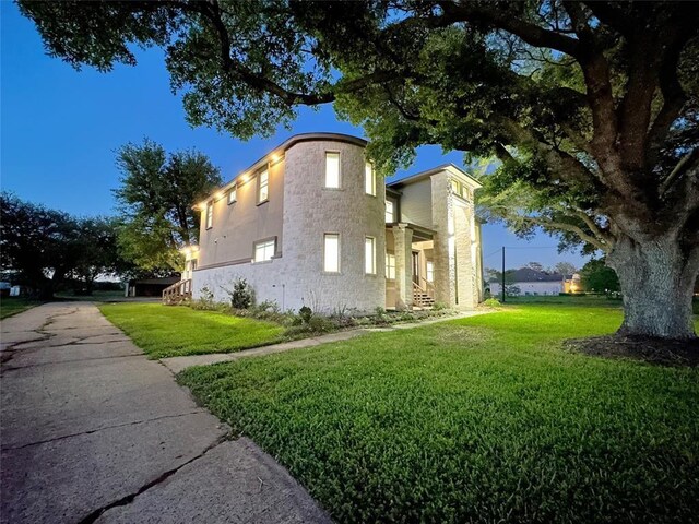 7737 Brookside Rd, Pearland, TX 77581 - view of side of home with a yard and stucco siding