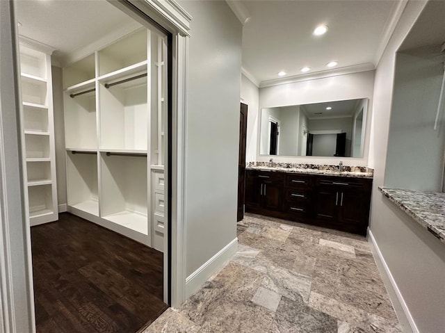 7737 Brookside Rd, Pearland, TX 77581 - bathroom with baseboards, ornamental molding, double vanity, stone finish flooring, and a walk in closet