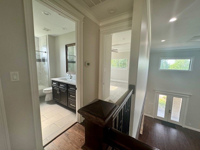 7737 Brookside Rd, Pearland, TX 77581 - bathroom with toilet, wood finished floors, vanity, tiled shower, and plenty of natural light