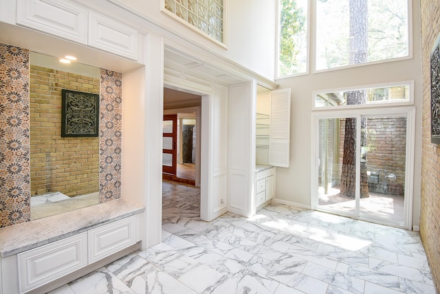 201 Vanderpool Ln Unit 27, Houston, TX 77024 - foyer entrance with a high ceiling, light marble finish flooring, and baseboards
