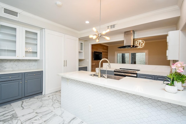 201 Vanderpool Ln Unit 27, Houston, TX 77024 - kitchen with a chandelier, island range hood, gas range, white cabinetry, and crown molding
