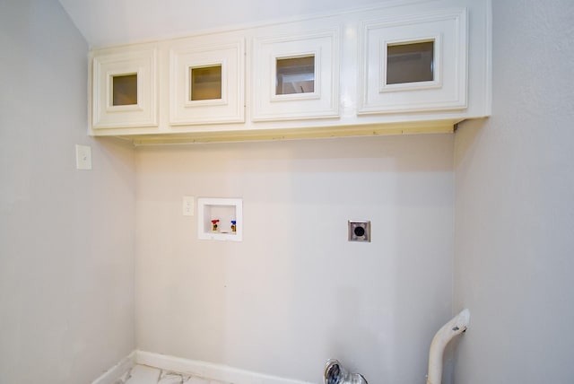 201 Vanderpool Ln Unit 27, Houston, TX 77024 - laundry area with cabinet space, light marble finish flooring, hookup for an electric dryer, washer hookup, and baseboards