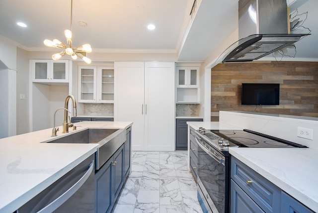 201 Vanderpool Ln Unit 27, Houston, TX 77024 - kitchen with stainless steel appliances, island exhaust hood, blue cabinets, a sink, and crown molding