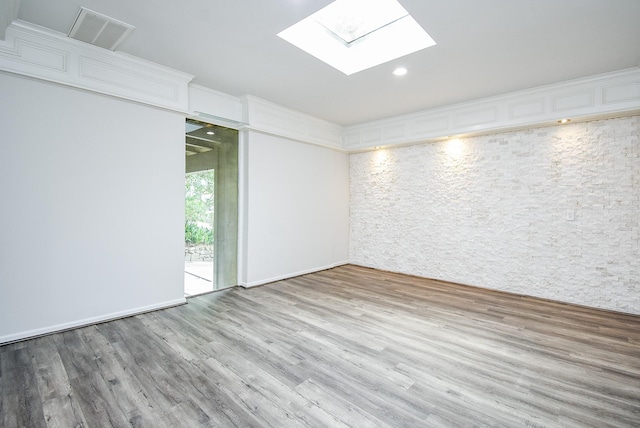 201 Vanderpool Ln Unit 27, Houston, TX 77024 - empty room with a skylight, wood finished floors, and recessed lighting