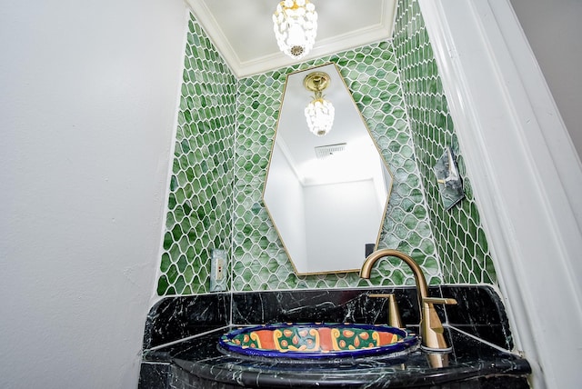201 Vanderpool Ln Unit 27, Houston, TX 77024 - bathroom with crown molding, tasteful backsplash, and a sink