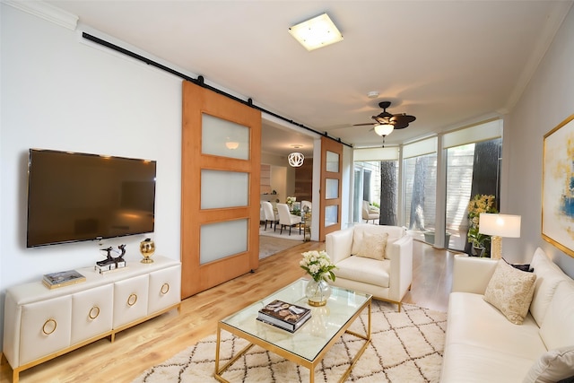 201 Vanderpool Ln Unit 27, Houston, TX 77024 - living room with a barn door, ceiling fan, light wood-style floors, a wall of windows, and crown molding