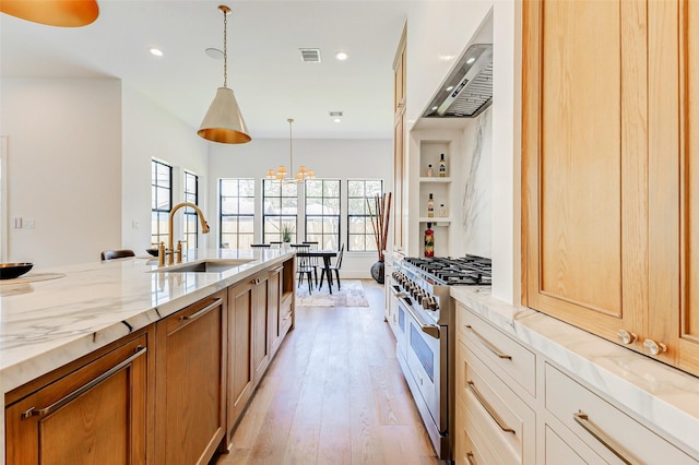 1810 Woodcrest Dr, Houston, TX 77018 - kitchen featuring a sink, double oven range, light stone countertops, light wood finished floors, and recessed lighting