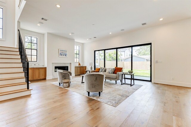 1810 Woodcrest Dr, Houston, TX 77018 - living area featuring plenty of natural light, light wood-style flooring, recessed lighting, stairway, and a fireplace