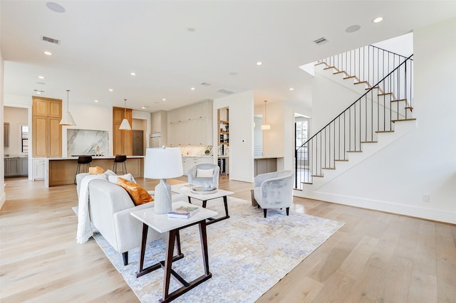 1810 Woodcrest Dr, Houston, TX 77018 - living room featuring light wood-style flooring, stairs, recessed lighting, and baseboards
