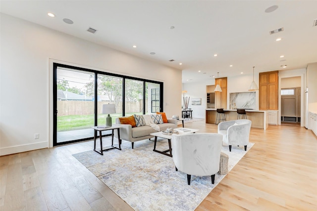 1810 Woodcrest Dr, Houston, TX 77018 - living area featuring light wood finished floors, recessed lighting, and baseboards