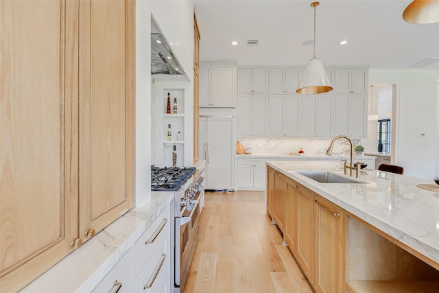 1810 Woodcrest Dr, Houston, TX 77018 - kitchen featuring a sink, high end appliances, light wood-style floors, light stone countertops, and pendant lighting