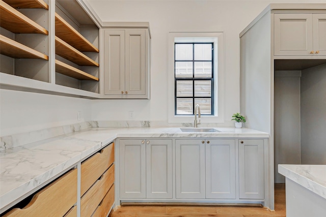 1810 Woodcrest Dr, Houston, TX 77018 - kitchen with a sink, open shelves, light stone countertops, and light wood-type flooring