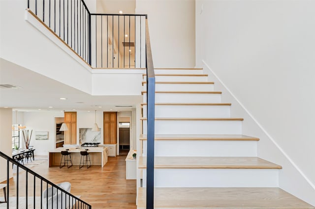 1810 Woodcrest Dr, Houston, TX 77018 - stairs with a towering ceiling, wood finished floors, and recessed lighting