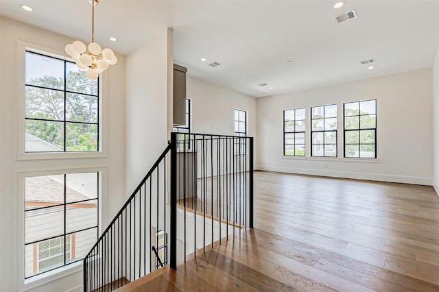 1810 Woodcrest Dr, Houston, TX 77018 - stairway with healthy amount of natural light, a chandelier, wood-type flooring, baseboards, and recessed lighting
