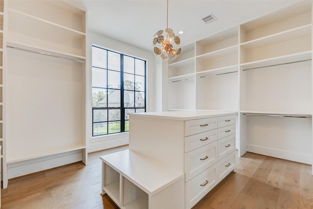 1810 Woodcrest Dr, Houston, TX 77018 - spacious closet with light wood-type flooring and a chandelier