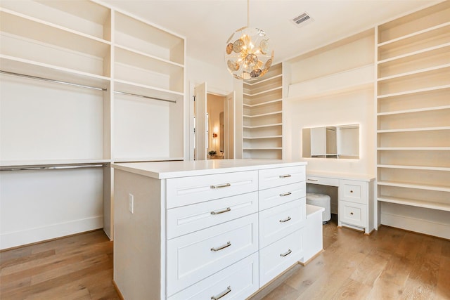 1810 Woodcrest Dr, Houston, TX 77018 - spacious closet featuring light wood-type flooring, a chandelier, and built in desk