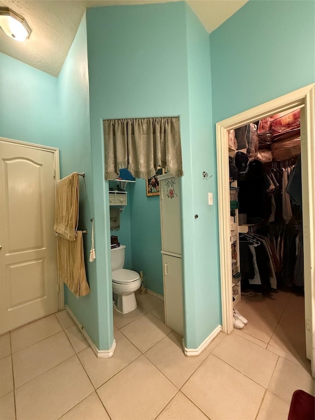 20122 Yellow Canyon Falls Dr, Tomball, TX 77375 - bathroom featuring tile patterned flooring, toilet, and baseboards