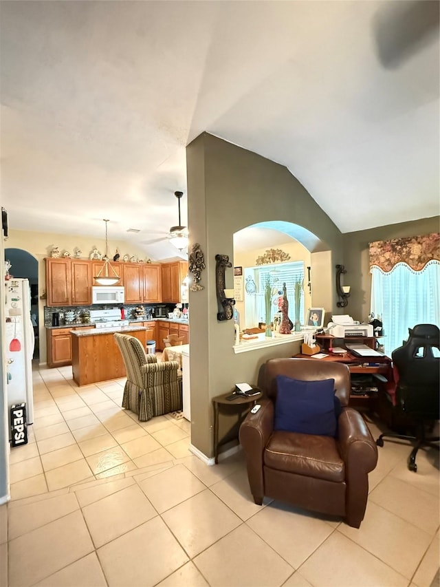 20122 Yellow Canyon Falls Dr, Tomball, TX 77375 - living room featuring vaulted ceiling, light tile patterned flooring, a ceiling fan, and arched walkways