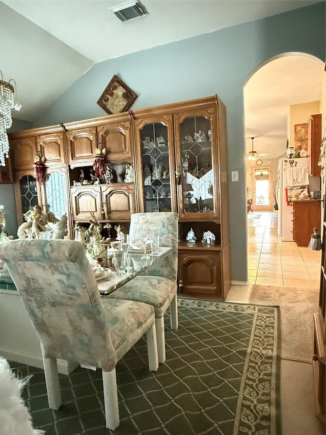 20122 Yellow Canyon Falls Dr, Tomball, TX 77375 - dining room with arched walkways, vaulted ceiling, and light tile patterned floors
