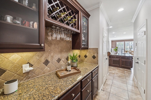 15718 Starcreek Ln, Houston, TX 77044 - bar with crown molding, tasteful backsplash, light tile patterned flooring, a sink, and recessed lighting