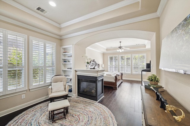 15718 Starcreek Ln, Houston, TX 77044 - living area featuring a raised ceiling, a multi sided fireplace, healthy amount of natural light, ceiling fan, and crown molding