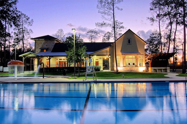 15718 Starcreek Ln, Houston, TX 77044 - pool at dusk with an outdoor pool and a lawn