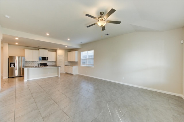 6531 Cody Mountain Trl, Richmond, TX 77407 - unfurnished living room featuring a ceiling fan, light tile patterned floors, recessed lighting, baseboards, and vaulted ceiling
