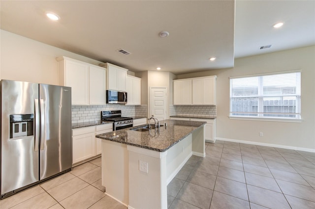 6531 Cody Mountain Trl, Richmond, TX 77407 - kitchen with appliances with stainless steel finishes, a sink, tasteful backsplash, light tile patterned floors, and recessed lighting