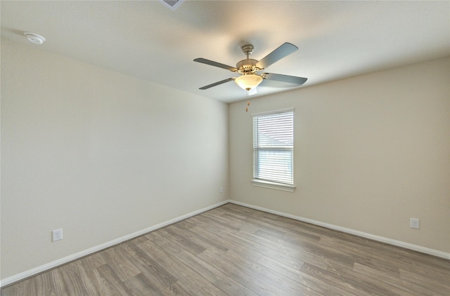 6531 Cody Mountain Trl, Richmond, TX 77407 - unfurnished room with light wood-type flooring, baseboards, a ceiling fan, and a smoke detector