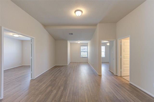 6531 Cody Mountain Trl, Richmond, TX 77407 - spare room featuring wood finished floors, baseboards, vaulted ceiling, and a ceiling fan