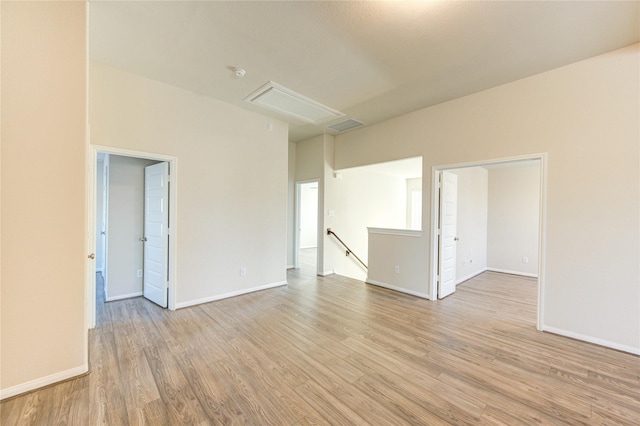 6531 Cody Mountain Trl, Richmond, TX 77407 - unfurnished room with attic access, light wood finished floors, baseboards, and a smoke detector