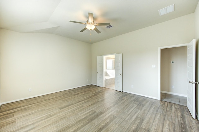 6531 Cody Mountain Trl, Richmond, TX 77407 - unfurnished bedroom featuring light wood finished floors, vaulted ceiling, ensuite bath, baseboards, and ceiling fan