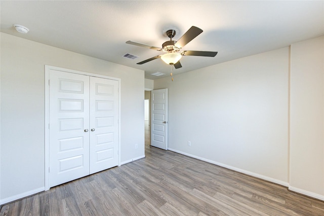 6531 Cody Mountain Trl, Richmond, TX 77407 - unfurnished bedroom featuring wood finished floors, baseboards, a closet, and ceiling fan