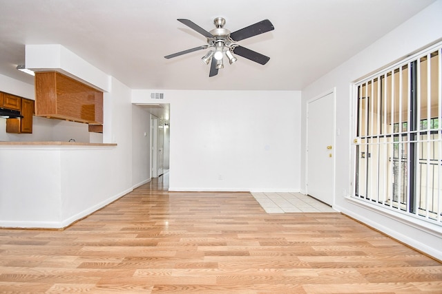 10100 S Gessner Rd Unit 308, Houston, TX 77071 - unfurnished living room featuring light wood-type flooring, ceiling fan, and baseboards