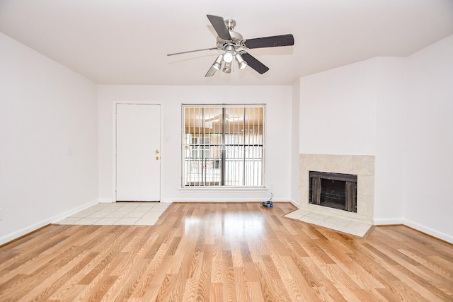 10100 S Gessner Rd Unit 308, Houston, TX 77071 - unfurnished living room with wood finished floors, ceiling fan, a fireplace, and baseboards