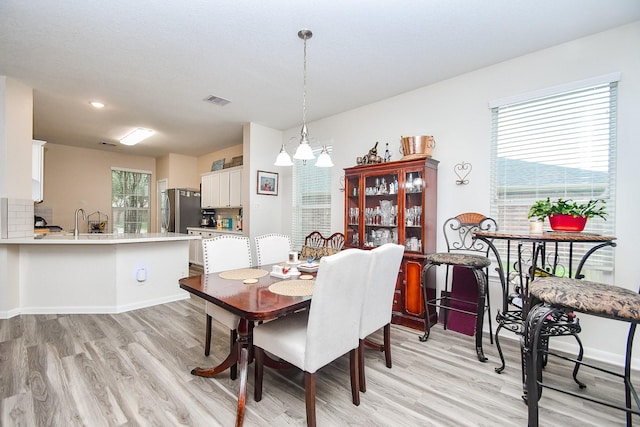 2206 Rocky Hollow Ln, Katy, TX 77450 - dining room featuring light wood-style floors, a chandelier, baseboards, and recessed lighting