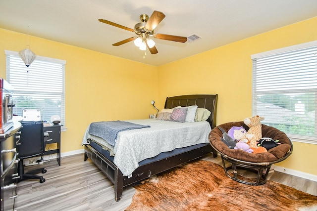 2206 Rocky Hollow Ln, Katy, TX 77450 - bedroom featuring wood finished floors, baseboards, and a ceiling fan