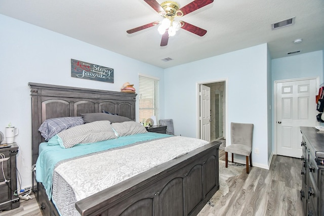 2206 Rocky Hollow Ln, Katy, TX 77450 - bedroom with light wood-style flooring, ceiling fan, and baseboards