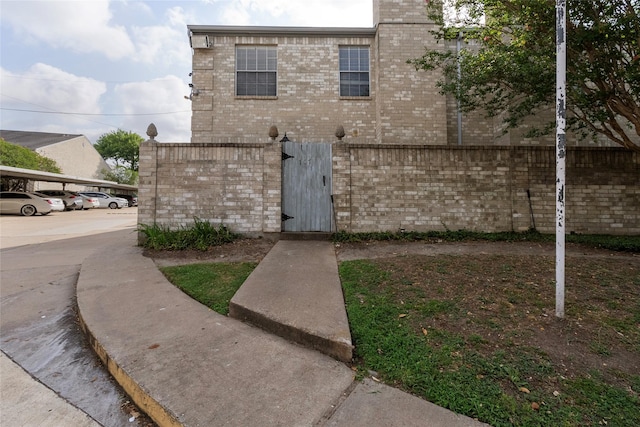 6500 Sands Point Dr Unit 107, Houston, TX 77074 - exterior space with brick siding, a gate, and uncovered parking
